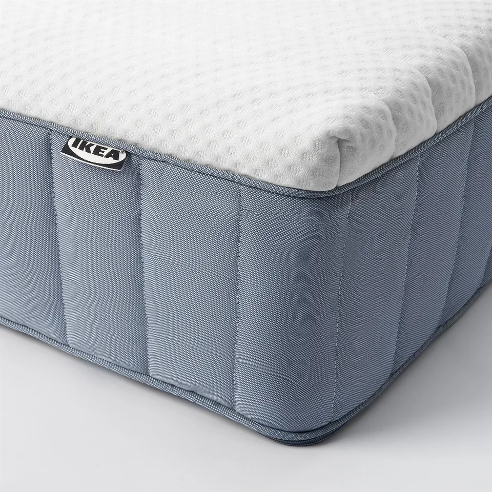 High-quality corner view of IKEA mattress, showcasing firm, textured surface and reinforced edge detail.