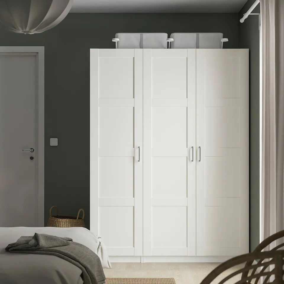 White BERGSBO wardrobe fits room, reaches ceiling, modern square design.