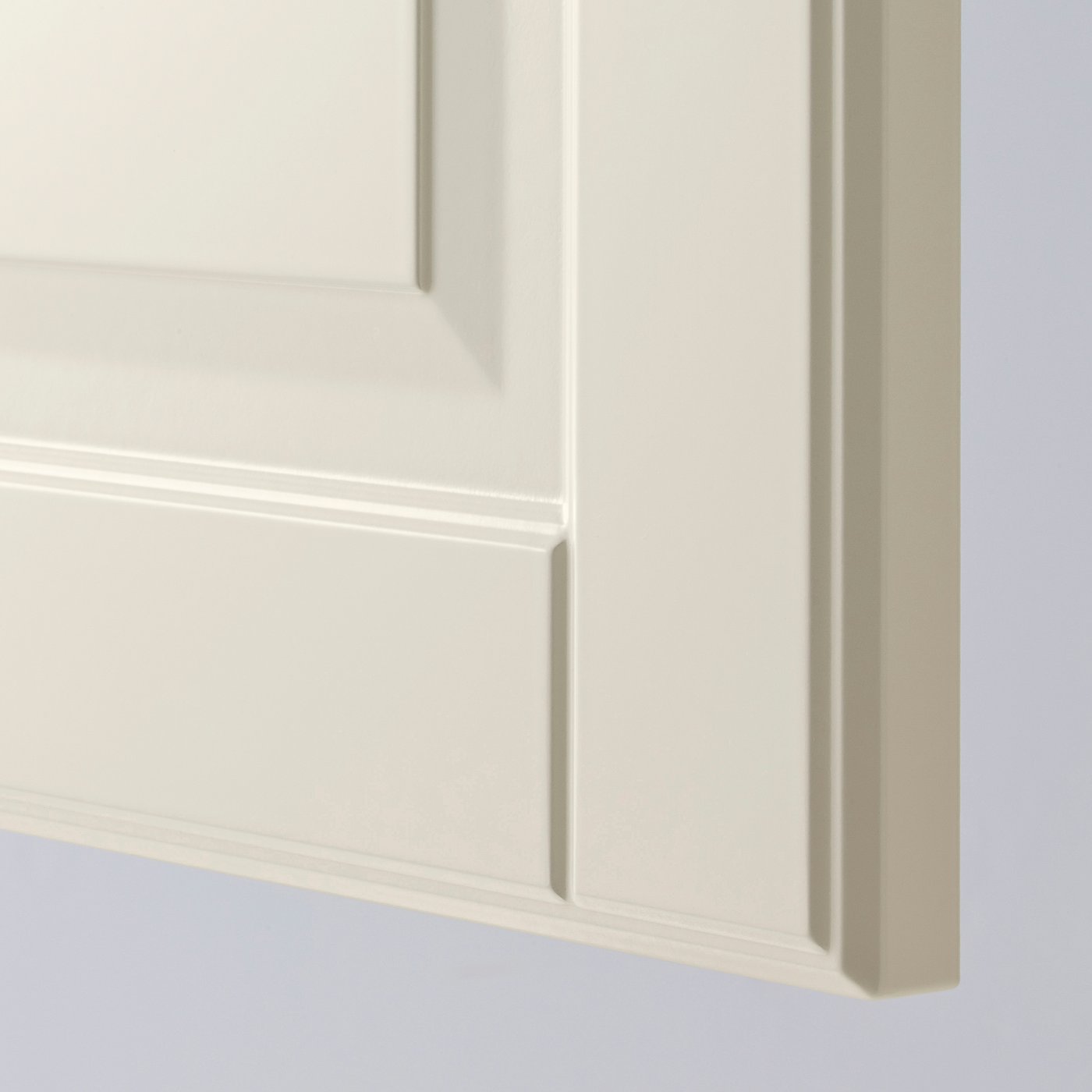 Close-up of smooth, off-white kitchen cabinet door with bevelled edges, showing high-quality finish and craftsmanship.