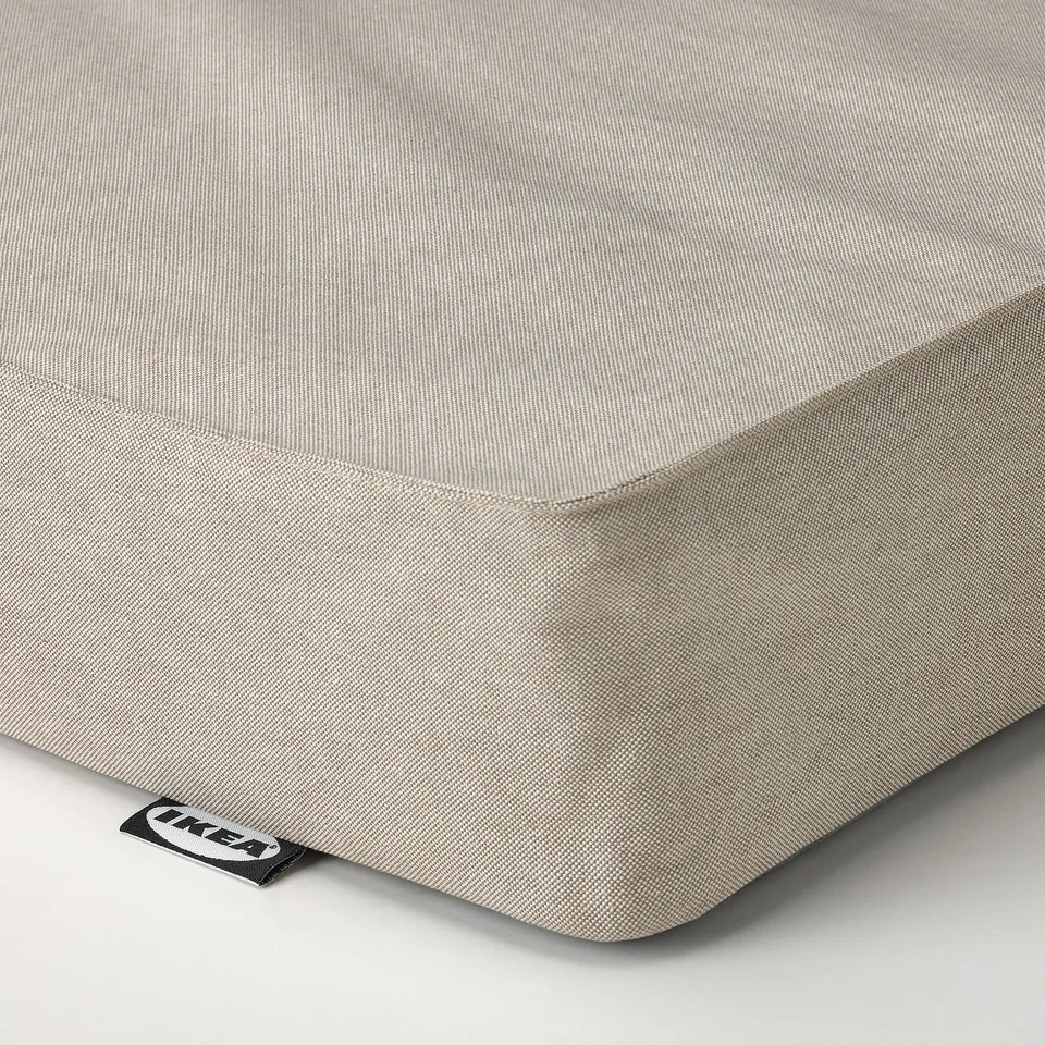 A close-up of a grey mattress corner. The fabric appears smooth and well-stitched, indicating quality and durability.