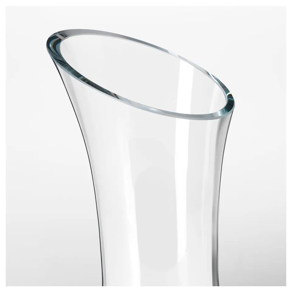 Sleek, clear glass carafe with smooth, curved edges; mouth blown for elegance.
