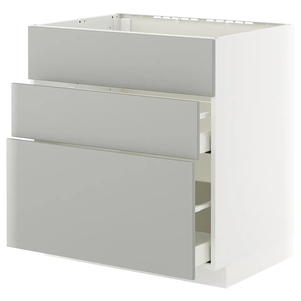 A white METOD kitchen unit with grey havstorp drawers in a modern design.