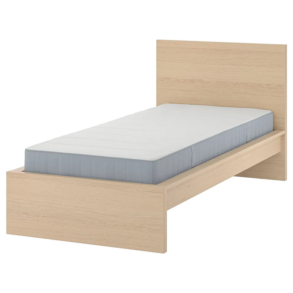 Light wood MALM bed with blue mattress, clean, modern. Headboard against white wall.