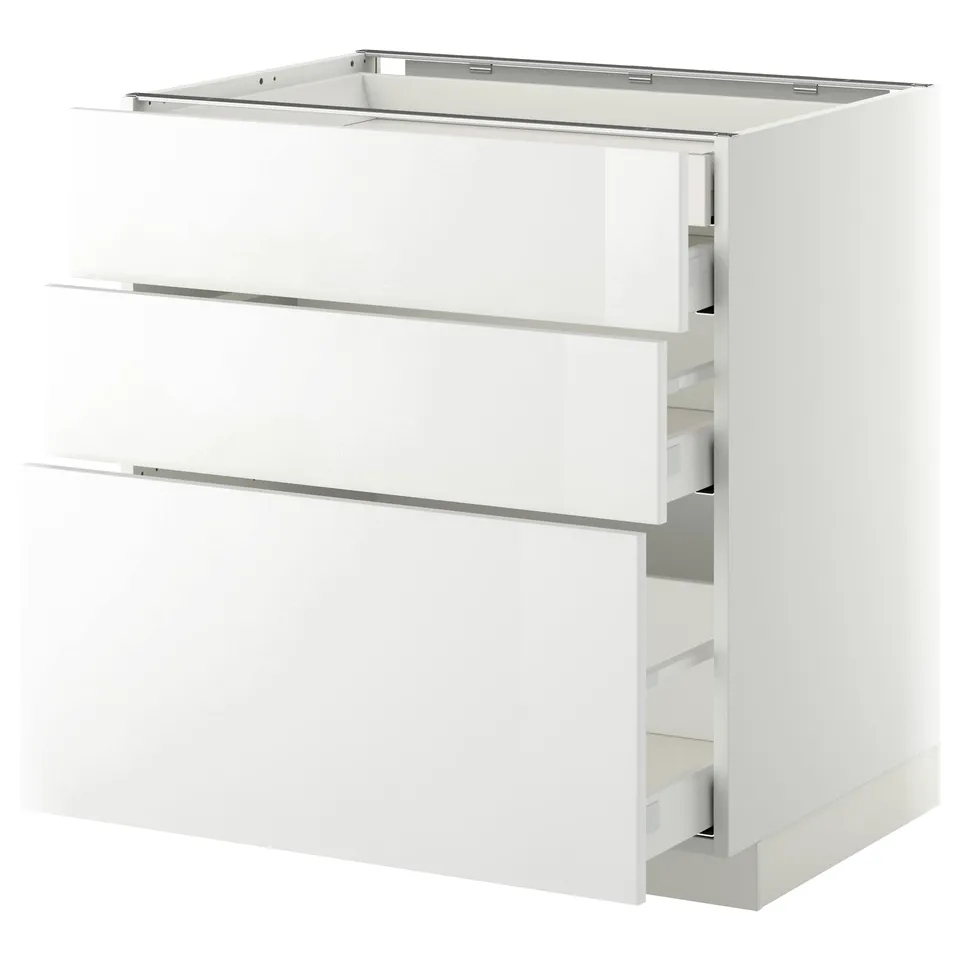 A white METOD kitchen cabinet with three drawers. The cabinet a high gloss finish and sleek design. The drawers are self-closing and run smoothly.