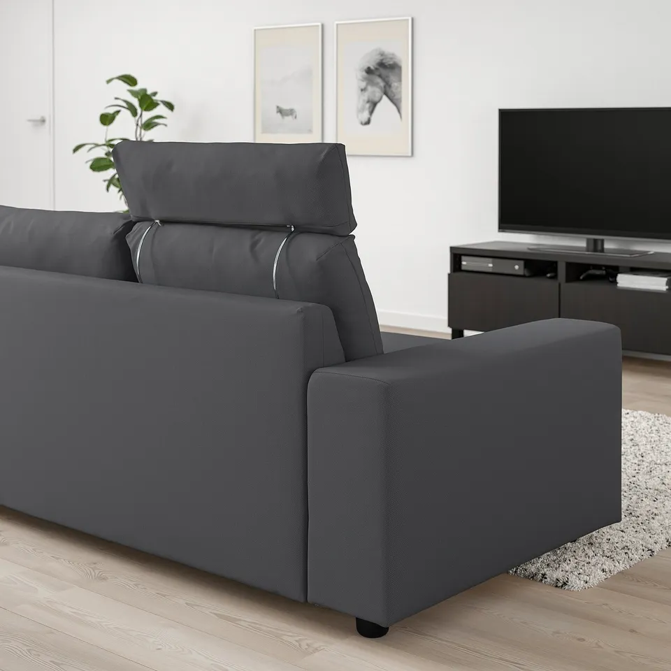 Modern grey VIMLE sofa in minimalist living room. Large, comfortable, with headrests and wide armrests. Huge tv and plant nearby.
