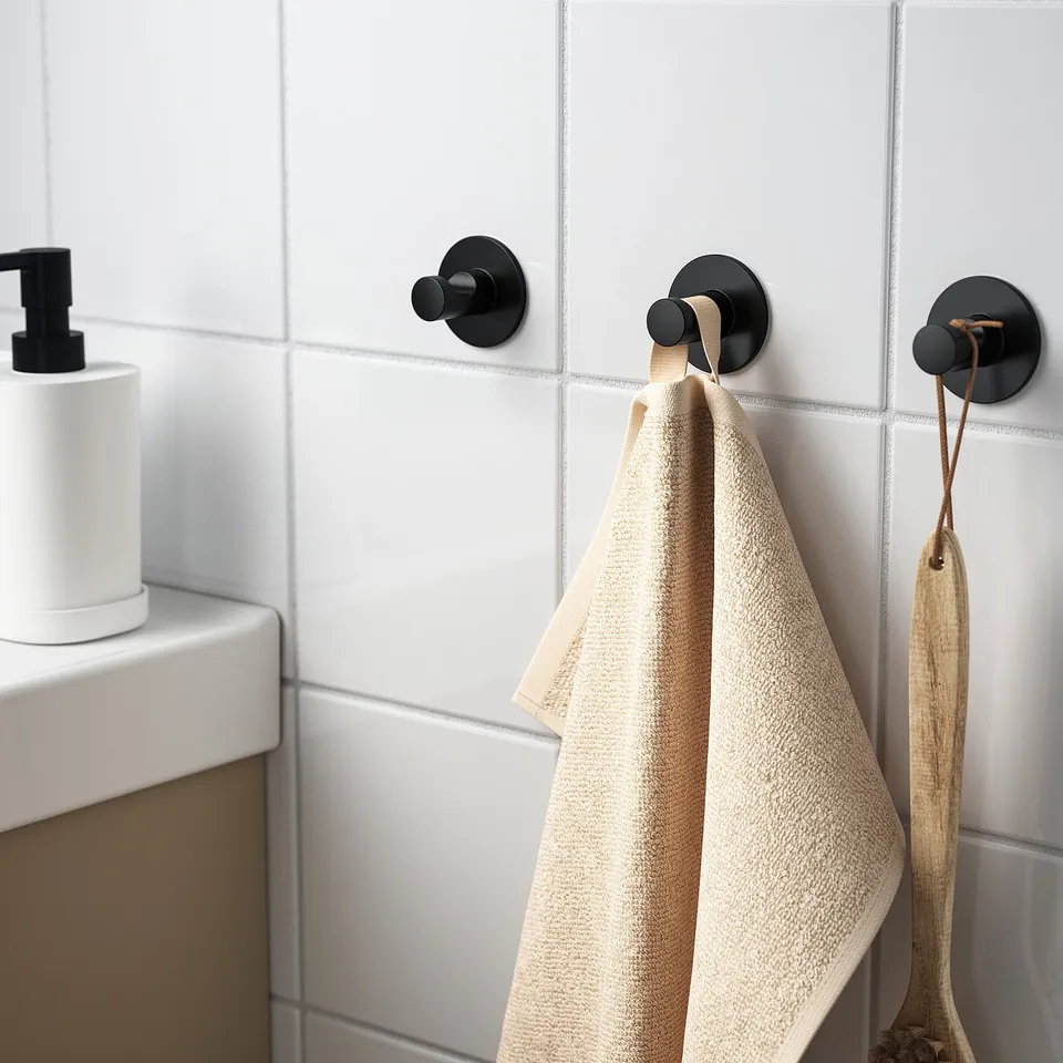 Three wall hooks: two with towel and utensil, adhesive-backed.