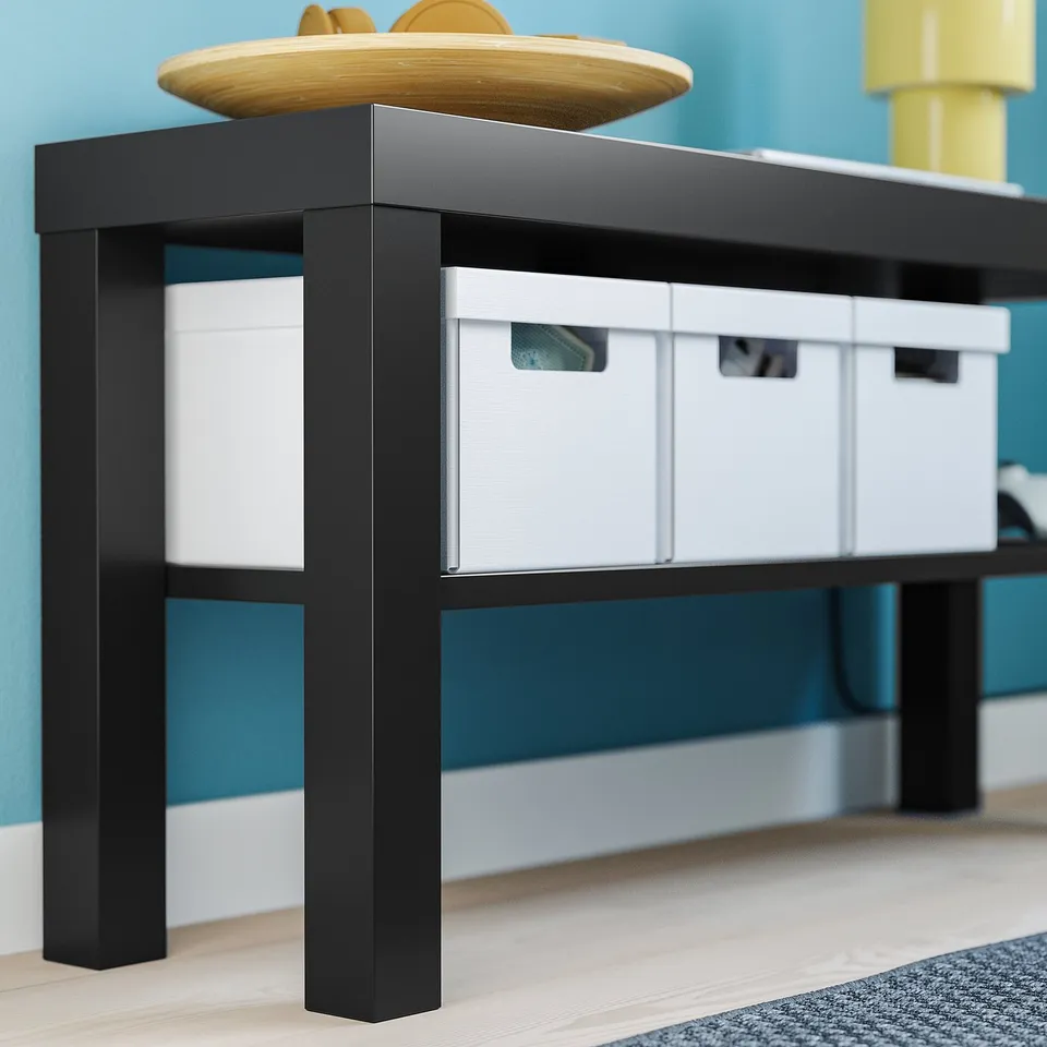 BLACK tv stand with three white storage boxes. Part of IKEAs LACK series. Wall-mountable for safety.
