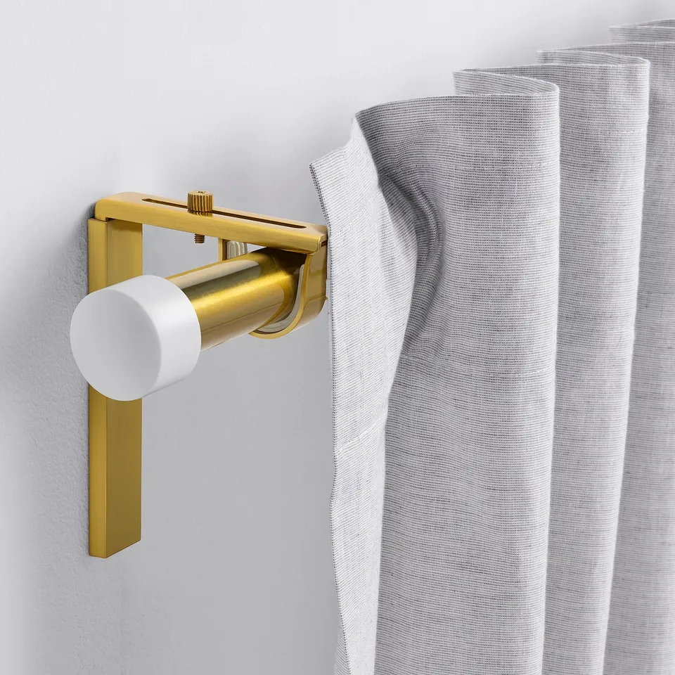 HUGAD gold curtain rod, sleek & adjustable, fits various spaces, shown next to light textile.