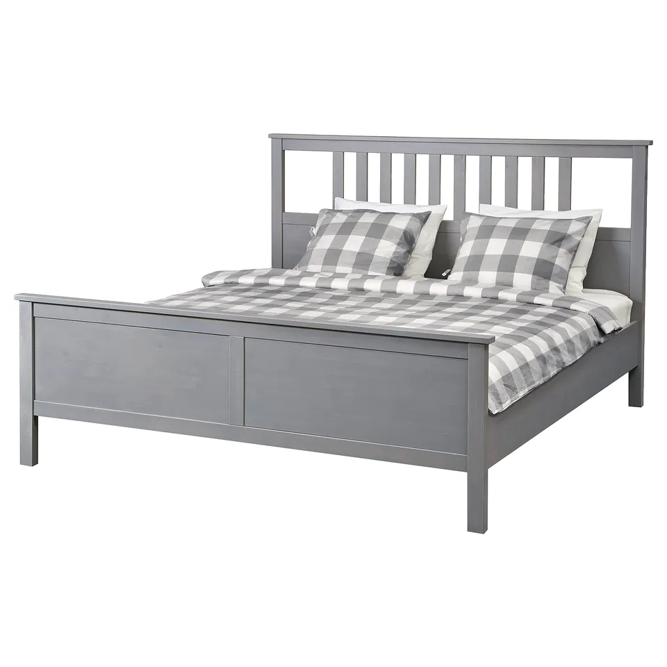 Grey HEMNES solid wood bed with slatted headboard, gray/white chequered bedding.