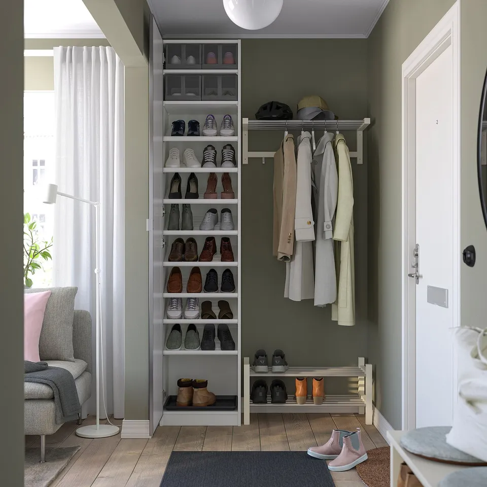 Organised entryway with shoe rack, hanging coats, and hat storage.