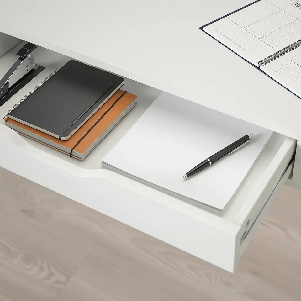 A sleek desk with drawers; stores items neatly. A pen rests on the smooth surface.