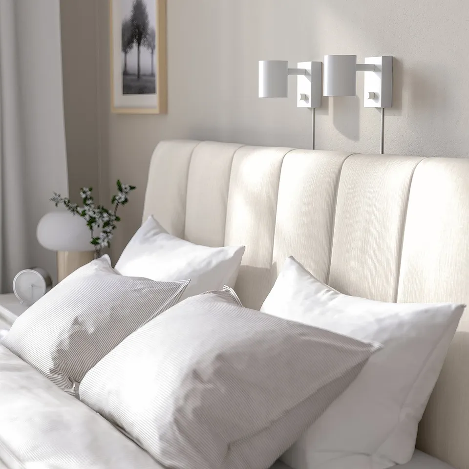 A modern bed with a padded headboard, clean lines, and adjustable bed sides for varied mattress thicknesses.