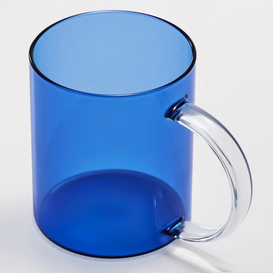 Clear, blue-tinted glass mug with a sturdy, transparent handle, perfectly shaped for a comfortable grip.