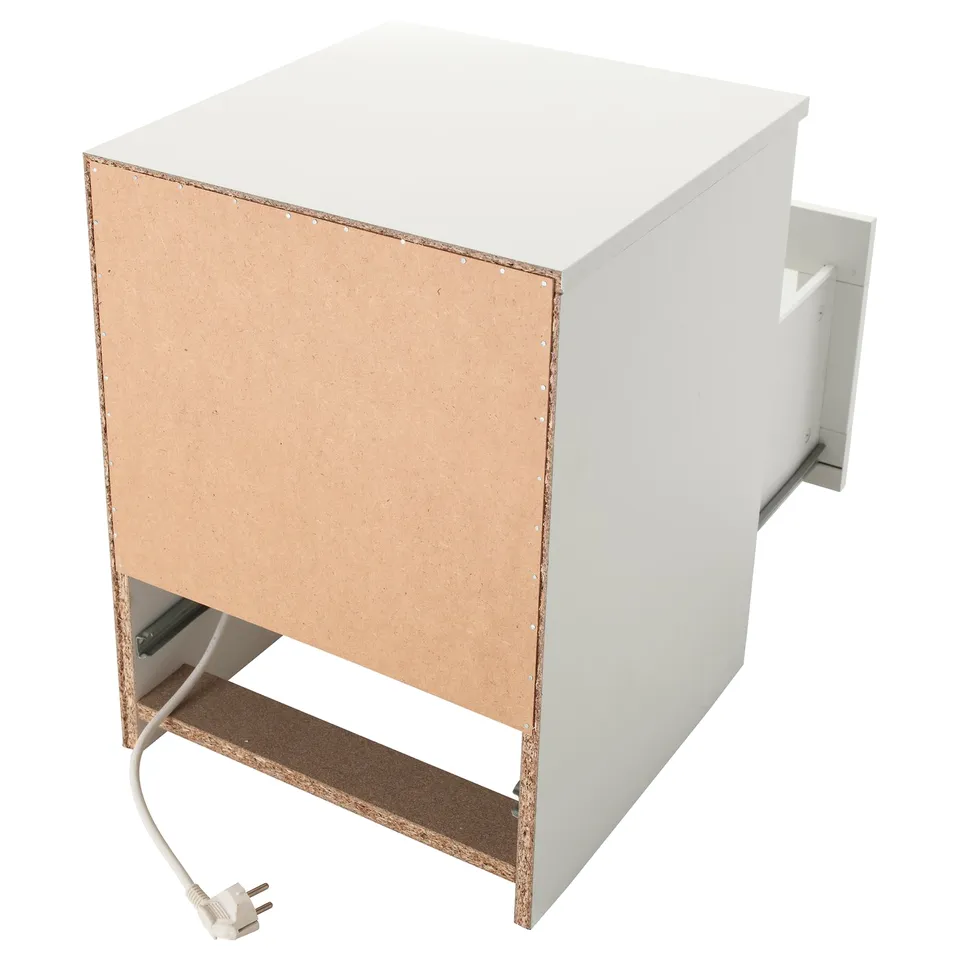 White wooden cabinet with open drawer, cable hole, and unplugged plug.