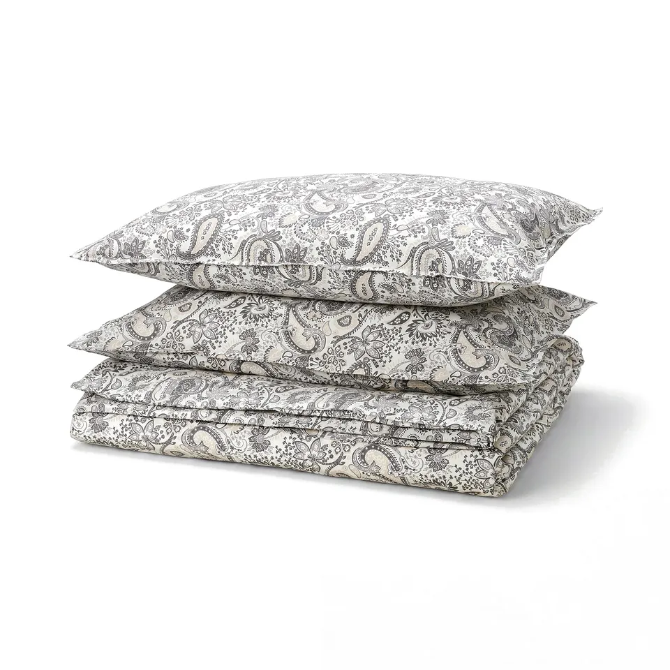 Grey RODGERSIA bedding with black paisley, cotton-viscose blend, folded duvet & pillows.