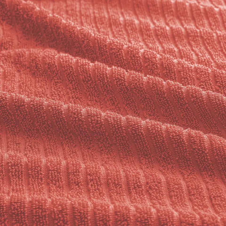Bright red towel with a soft, plush texture and visible ribbed weave, suggesting quality and absorbency.