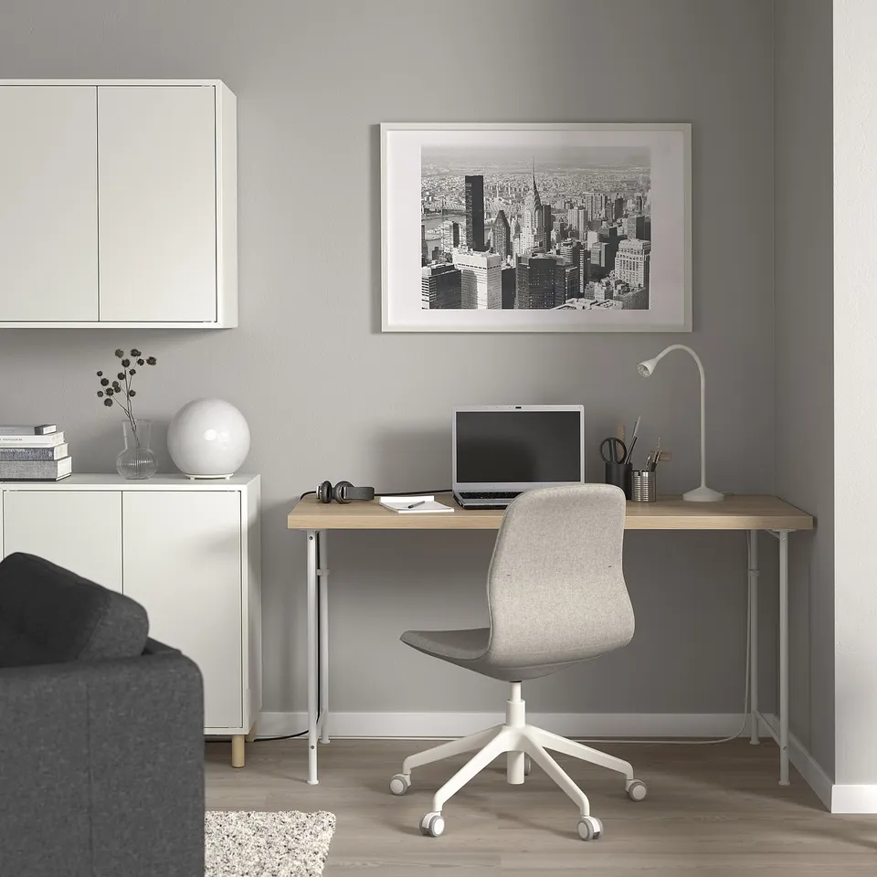 Modern home office with LAGKAPTEN desk, grey chair, computer, and minimalist decor.
