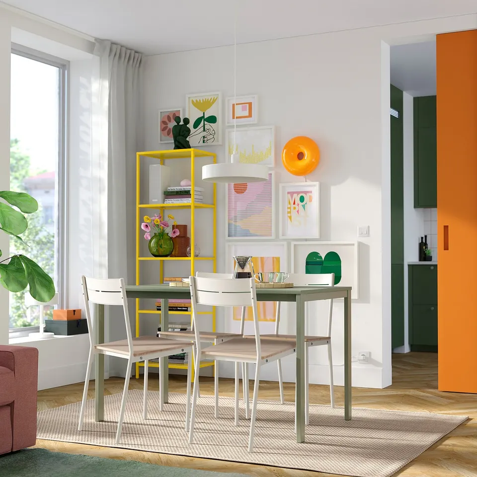 Modern dining area with VIHALS table, chairs, and gallery wall.