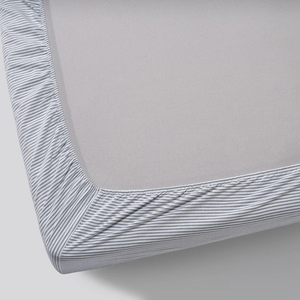 Grey fitted sheet with blue stripes on edges, neatly displayed, made of 100% cotton.
