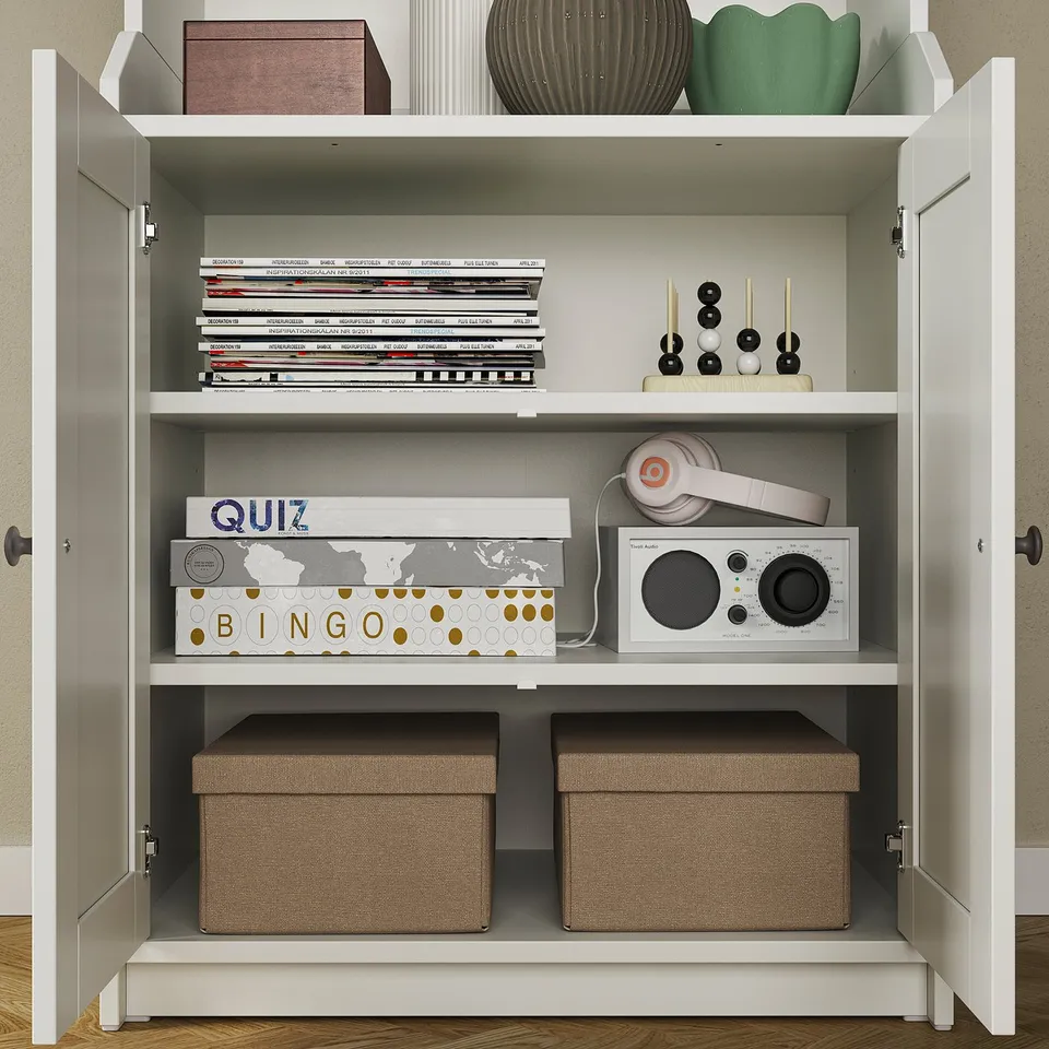 HAUGA storage with mixed shelves, books, headphones, games, and decor.