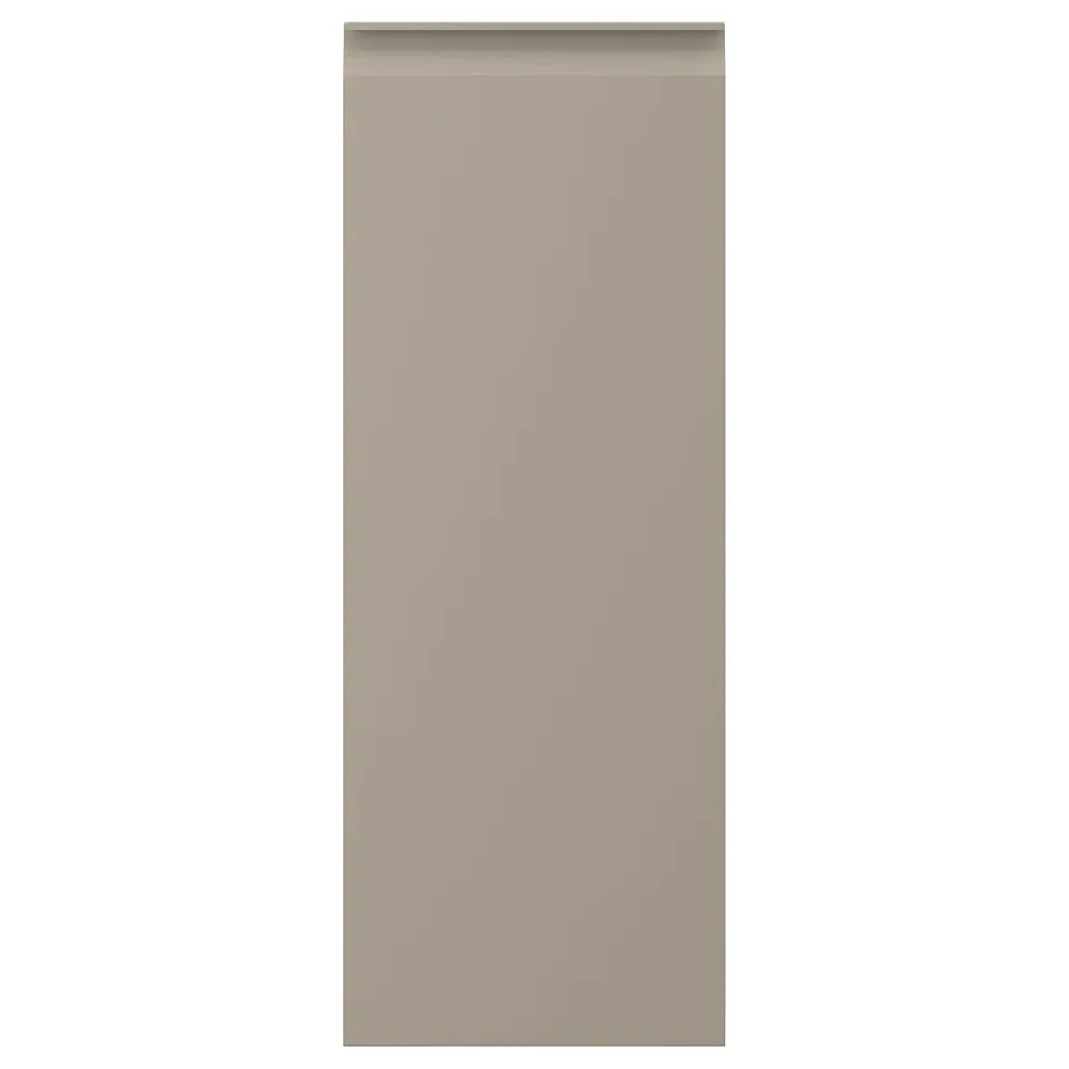 A modern kitchen cabinet door in matt beige with integrated handles. The door is rectangular and has a sleek, minimalist design with chamfered edges.
