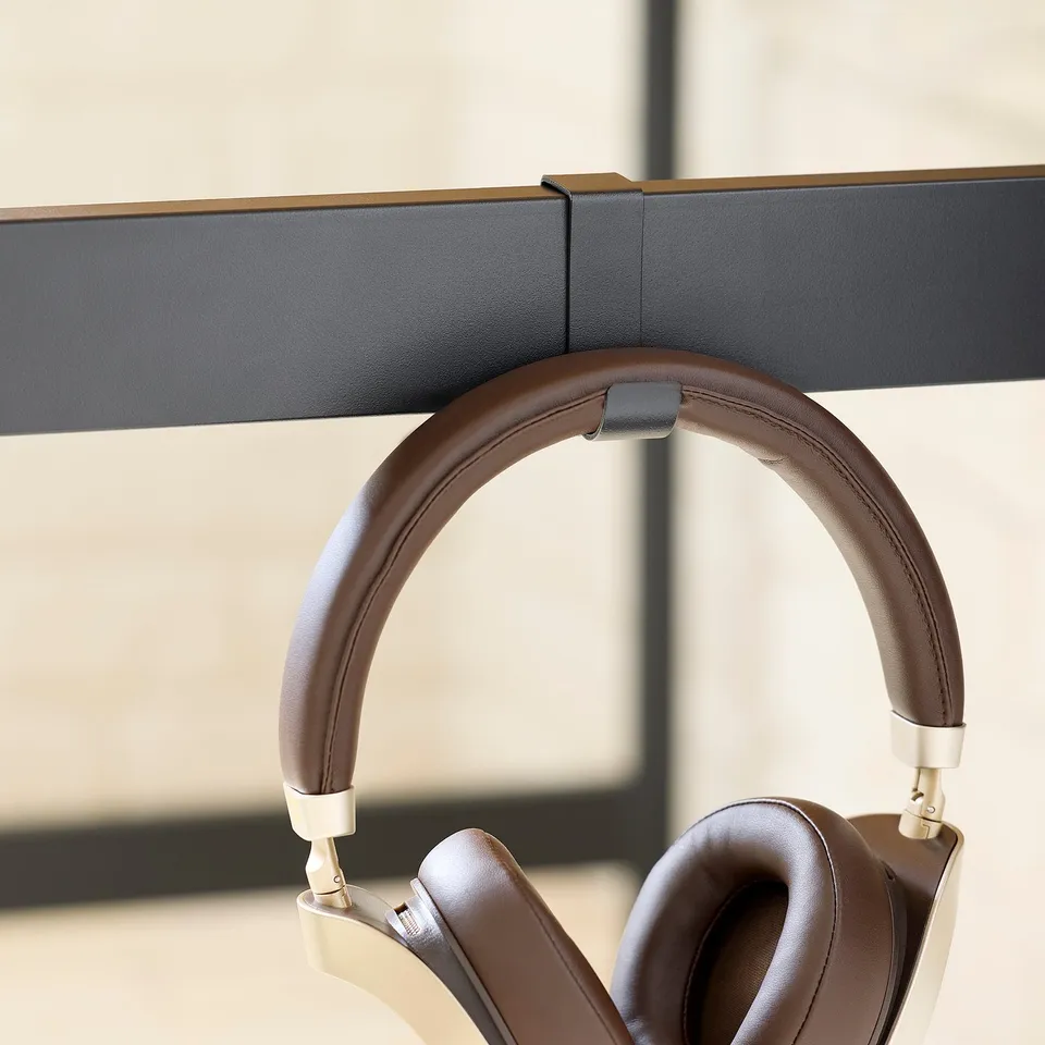 Leather headphones hang on wall stand.