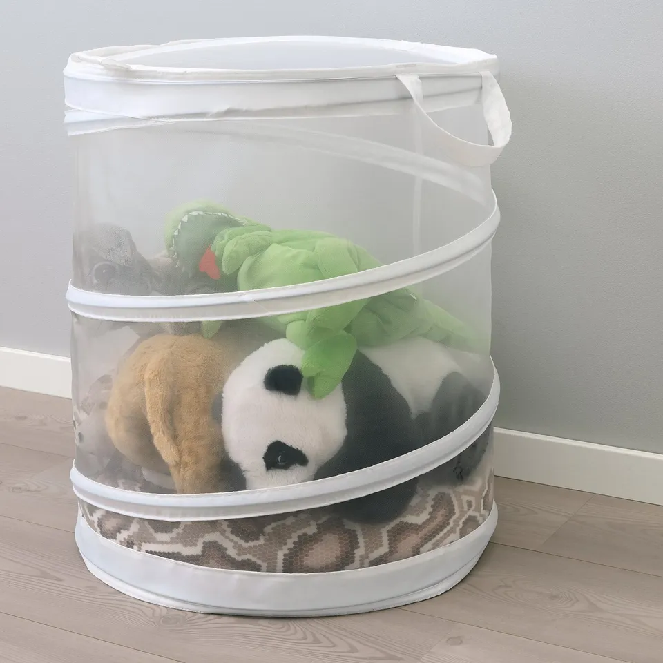 Clear round laundry basket with handles holding stuffed animals, a practical way to store soft toys.