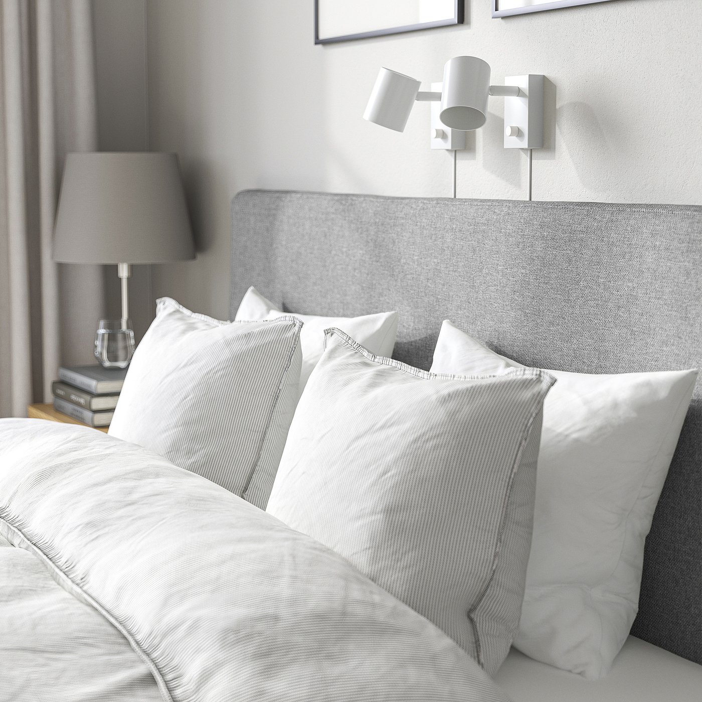 Clean, modern bed with padded headboard, grey cover, and integrated reading lights.