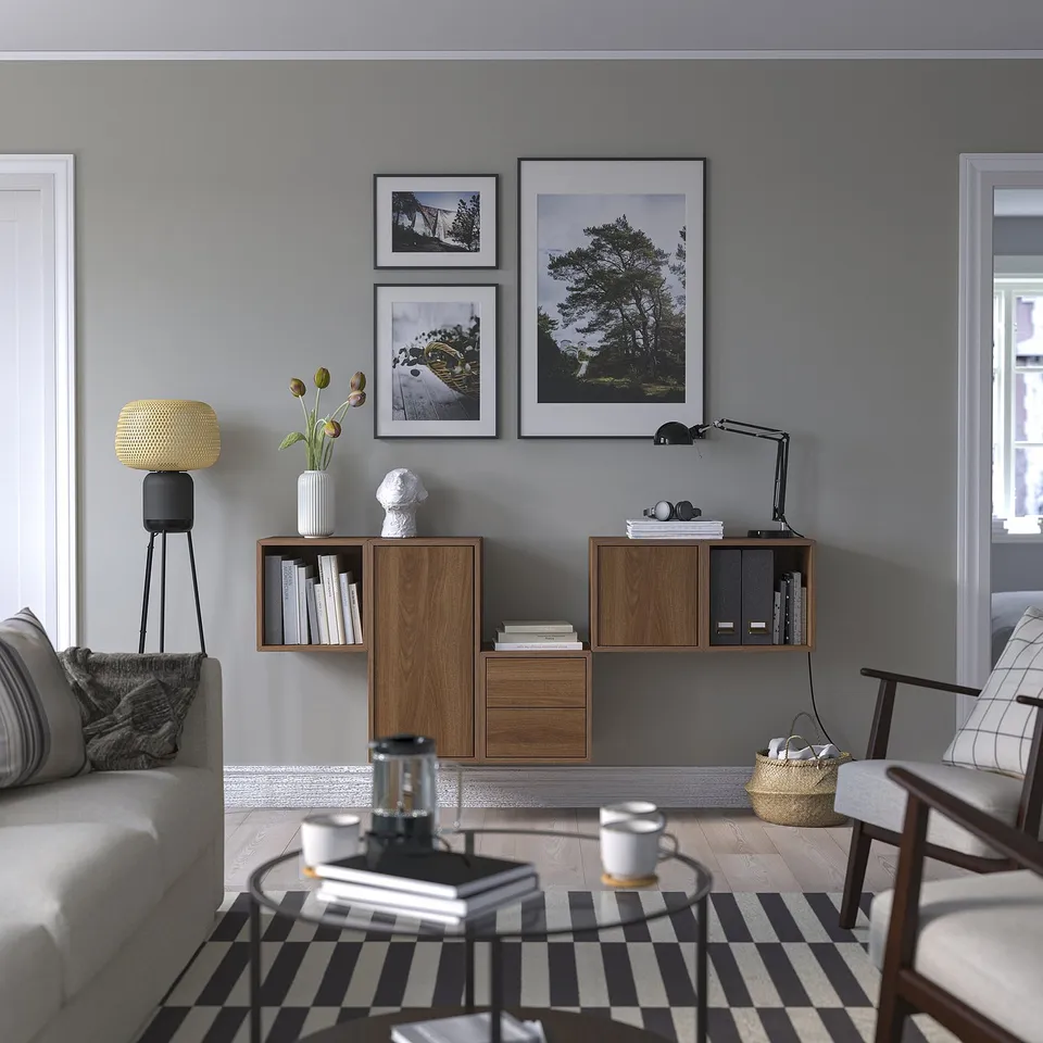 Modern living room with grey walls, EKET cabinets, striped rug, grey sofa, and glass-topped coffee table.