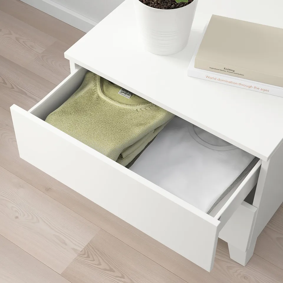 White PLATSA unit open drawer revealing folded light green sweater. Drawer holds around 8 pairs of folded trousers or 16 t-shirts.