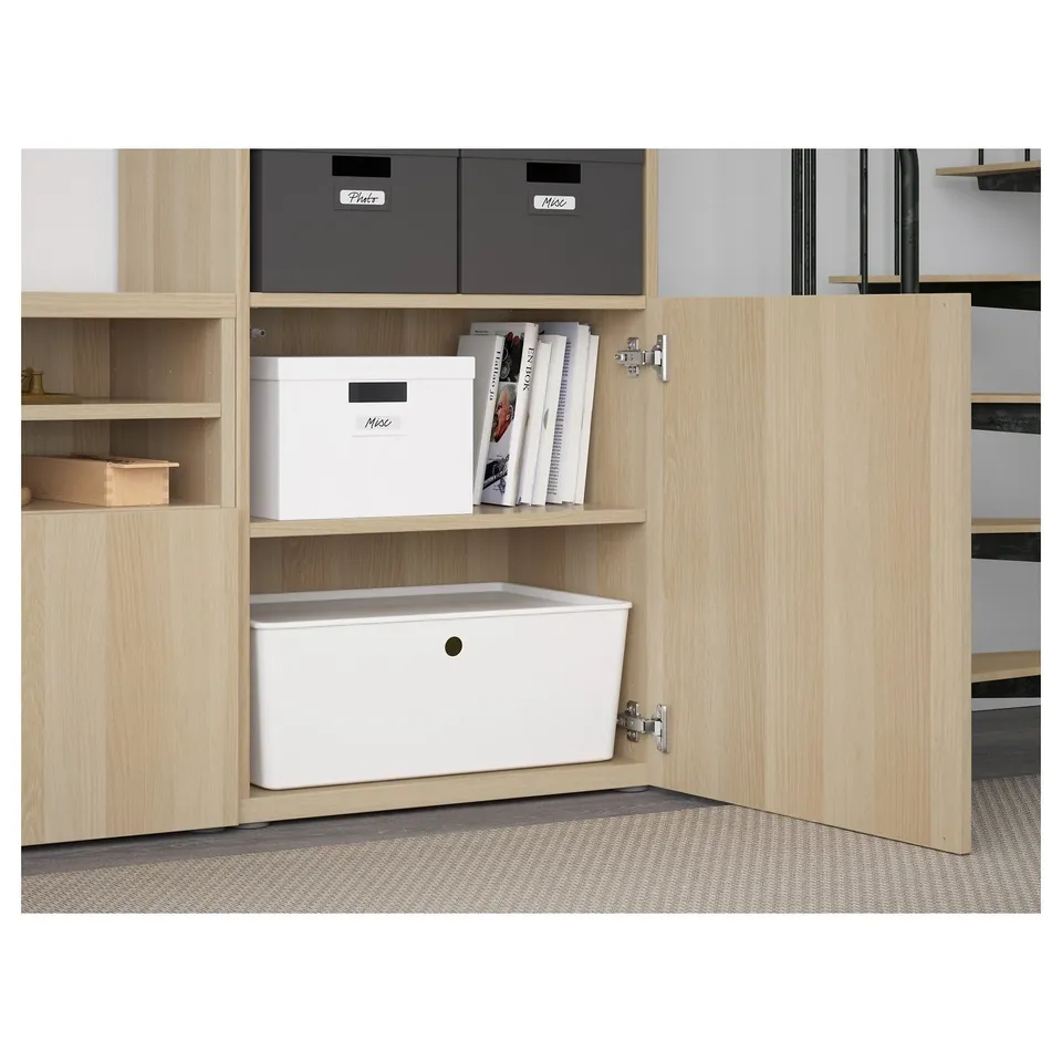 Wooden storage unit with adjustable shelves, closed cabinets, and drawers. Grey and white labelled boxes stored neatly.
