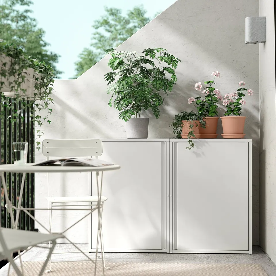 Modern outdoor space with white SUNDSÖ cabinet, plants, and table.