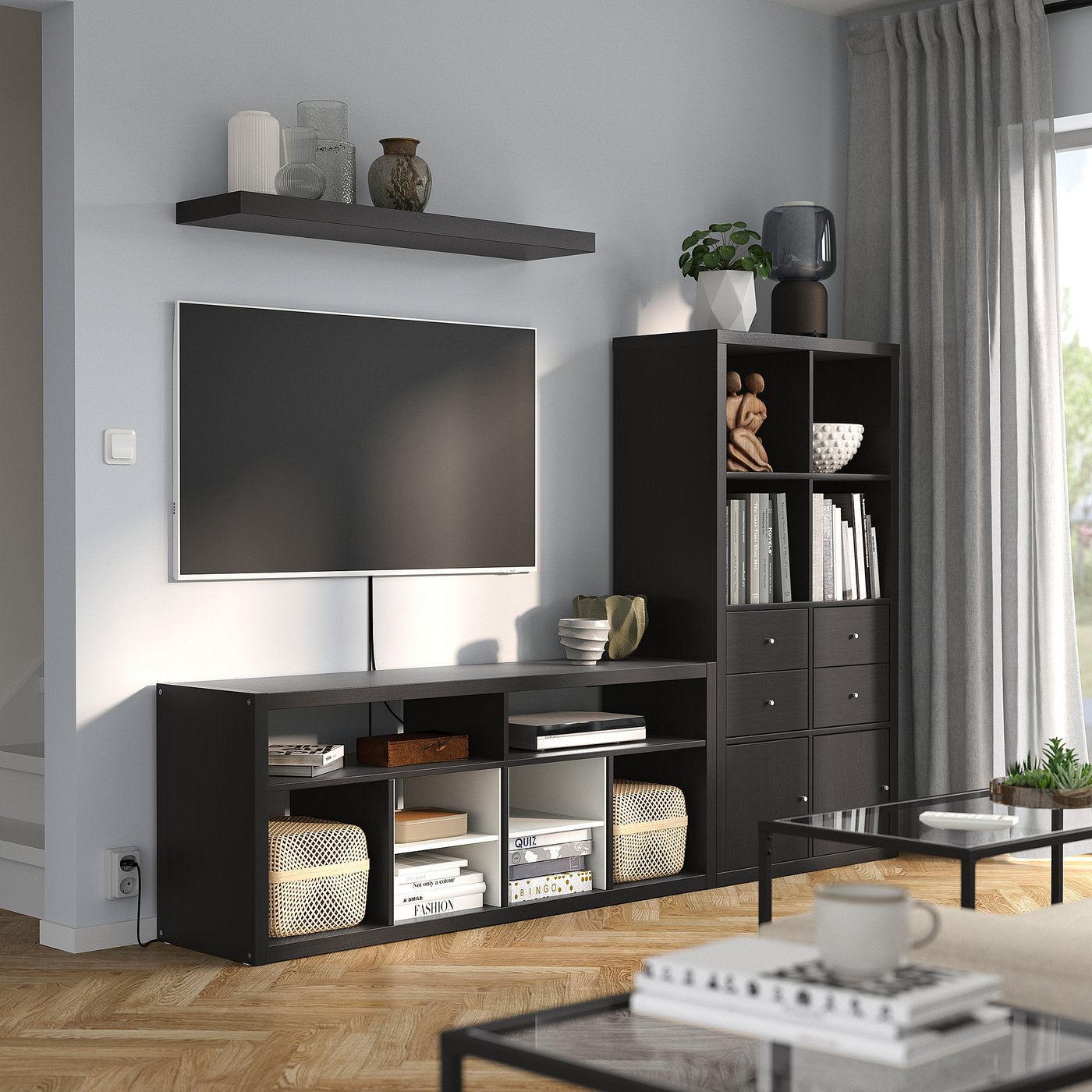 Modern living room with KALLAX black tv stand, shelf, and unit. Tv centred, grey curtains, wooden floor.