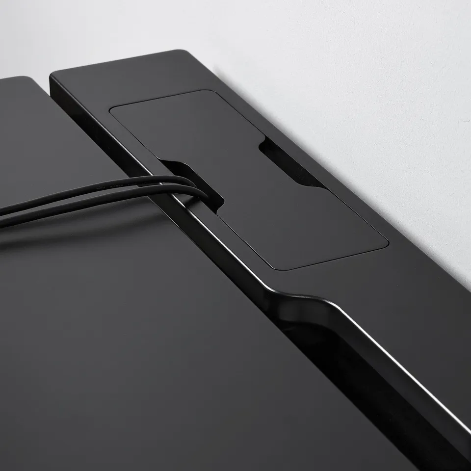 Close-up of a black gaming desks edge, showing sleek design and quality materials.