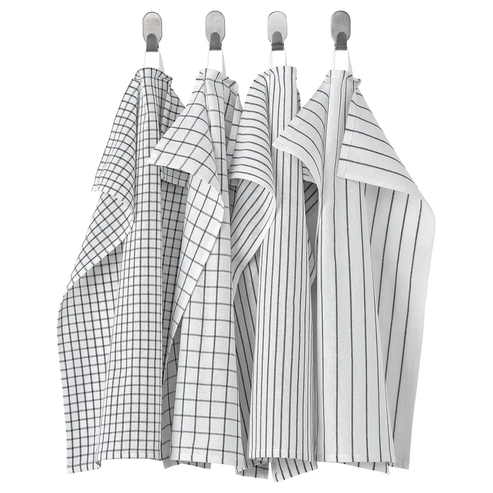 Four hanging towels in black/white grid, stripe, and solid patterns, made of 100% cotton, featuring loops for easy storage.