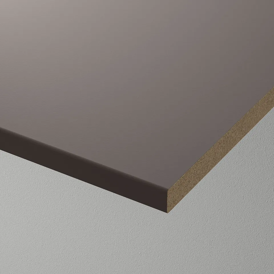 Dark grey shelf with textured surface, smooth feel, leaning against white wall.
