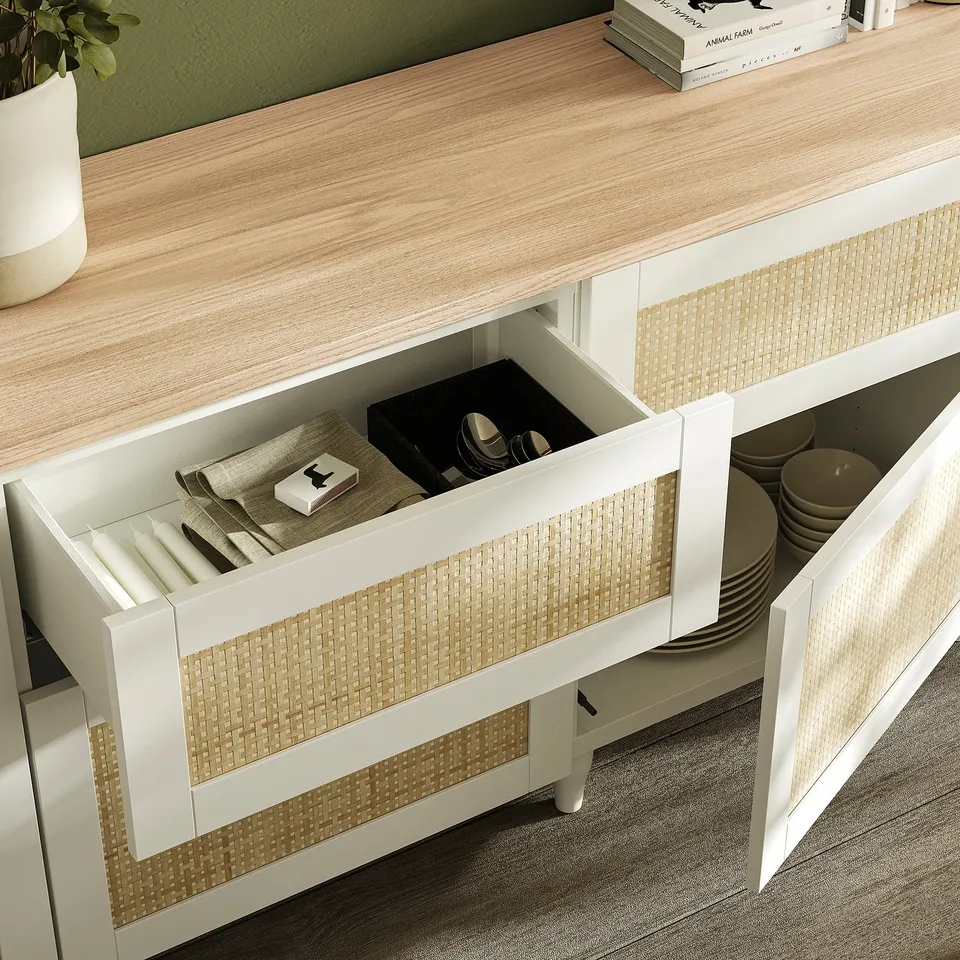 White kitchen drawer set with cutlery tray, plates, and books.