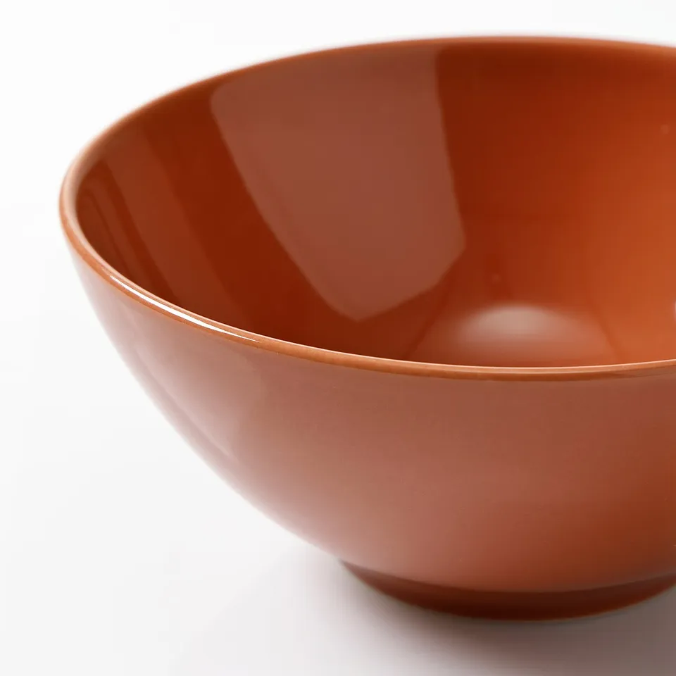 Rustic brown bowl with smooth, glazed finish; thick rim and sturdy base.