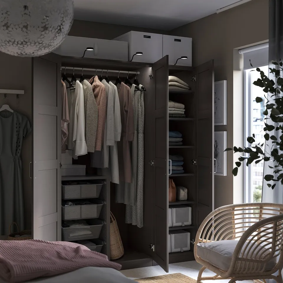 PAX wardrobe, dark brown, organised with clothes, shelves, drawers, and storage boxes.