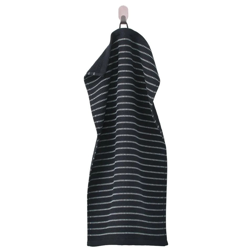 A black BROKGINST towel with a white waffle pattern, hung up. Made of 100% cotton, featuring terry and waffle textures.