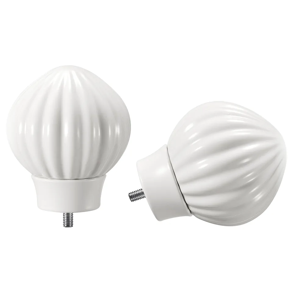 Two white, fluted ceramic finials for curtain rods, one detached.