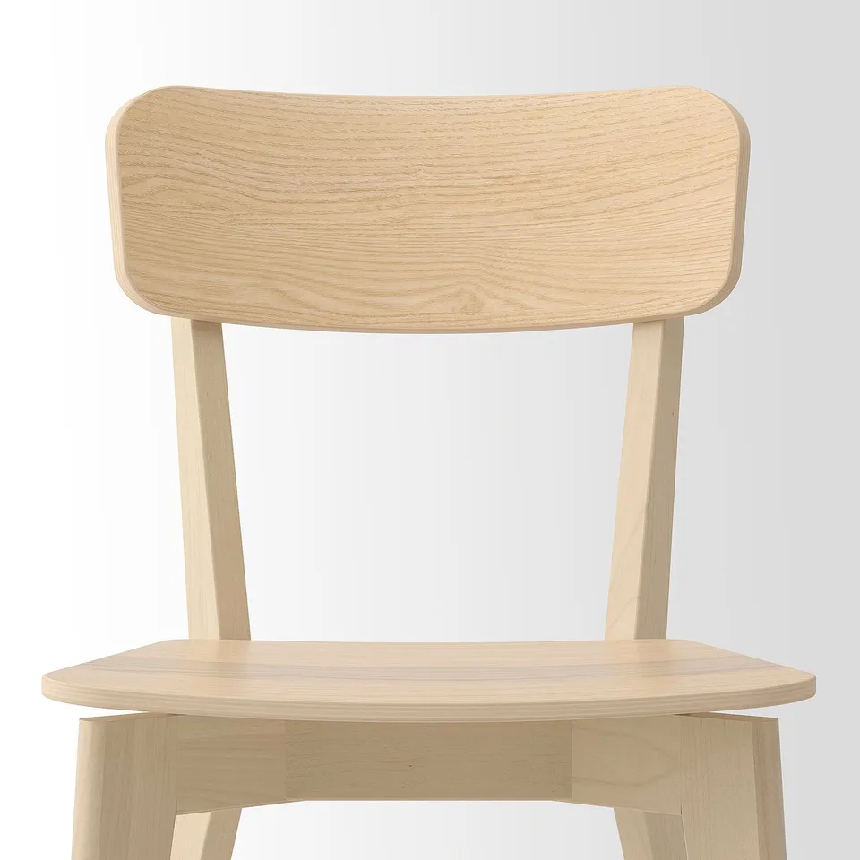 Light wooden chair with smooth, natural finish. Sleek backrest and seat, supported by sturdy legs.