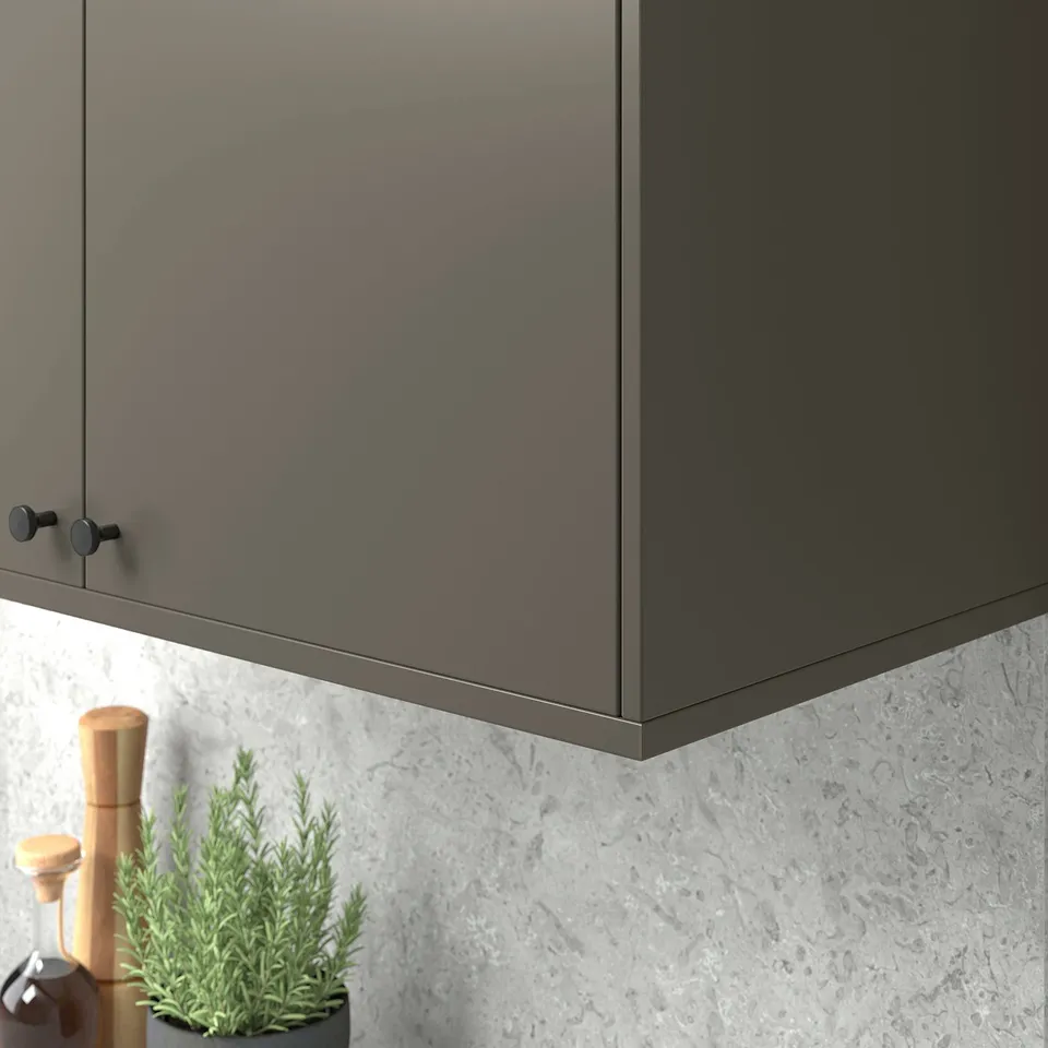 Grey kitchen cabinet with hidden handles and spice grinders.