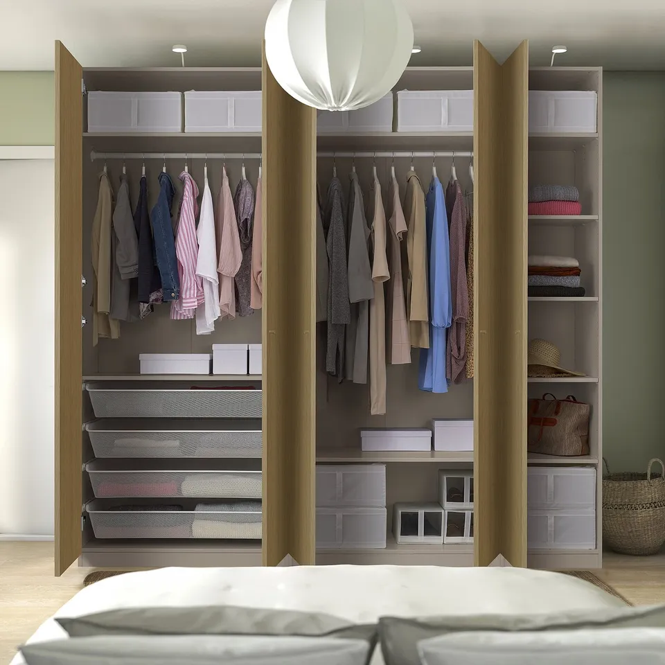 Modern wardrobe with clothes hangers, shelves, and storage boxes, integrated lighting.