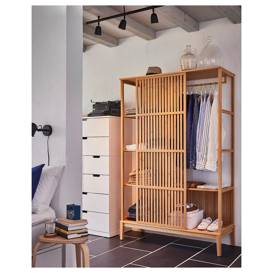 The NORDKISA wardrobe bamboo, clear acrylic lacquer, and a modern scandinavian design with clean lines, providing both storage and privacy.
