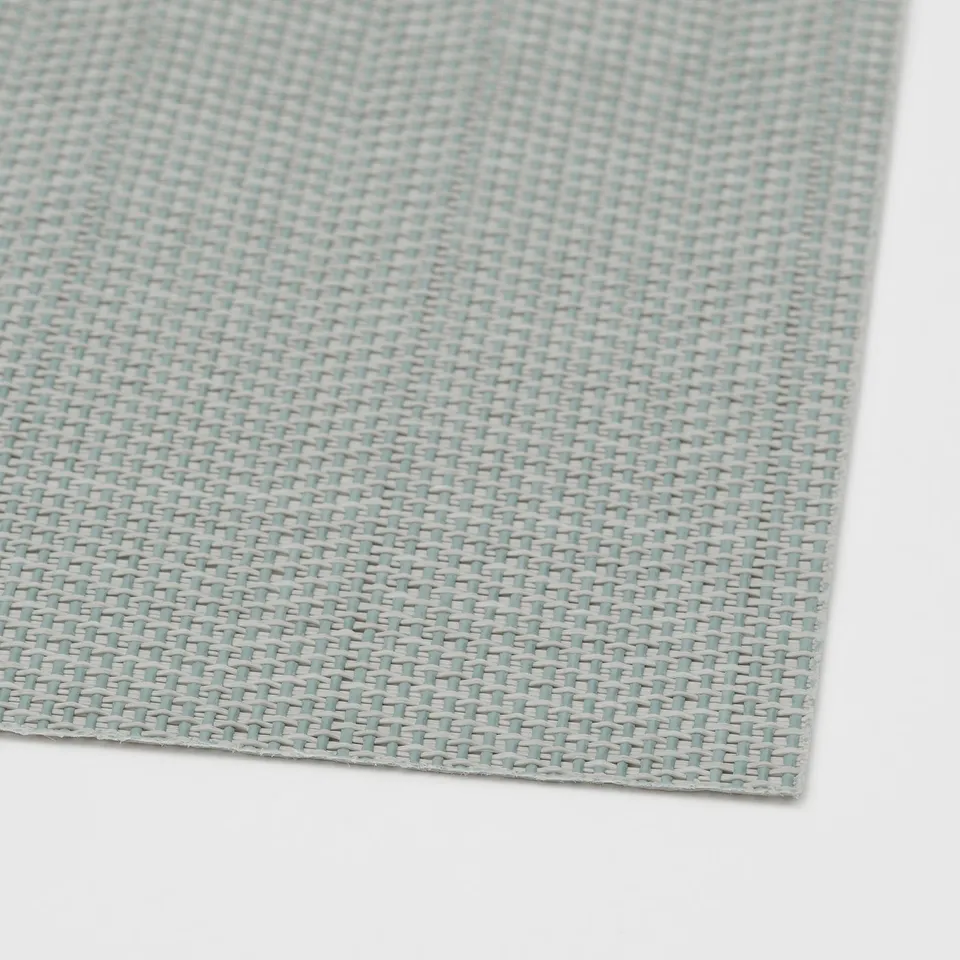 Close-up of woven light blue FLYGFISK place mat, showing fine texture and quality.