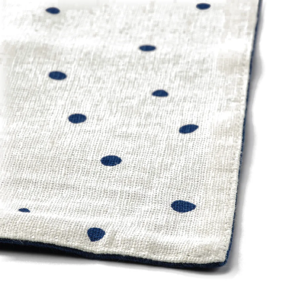 Reversible, cream-dotted place mat with tight weave, soft texture, and clean finish.