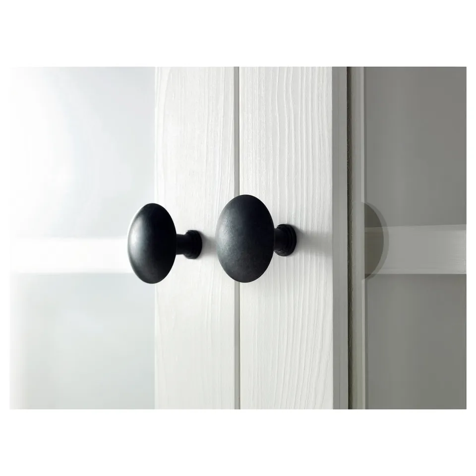 Black door knobs on white door