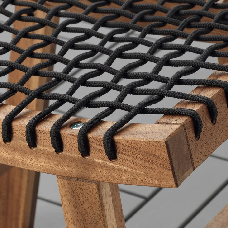 Close-up of high-quality acacia wood outdoor stool with intricately braided seat, showcasing durable craftsmanship.