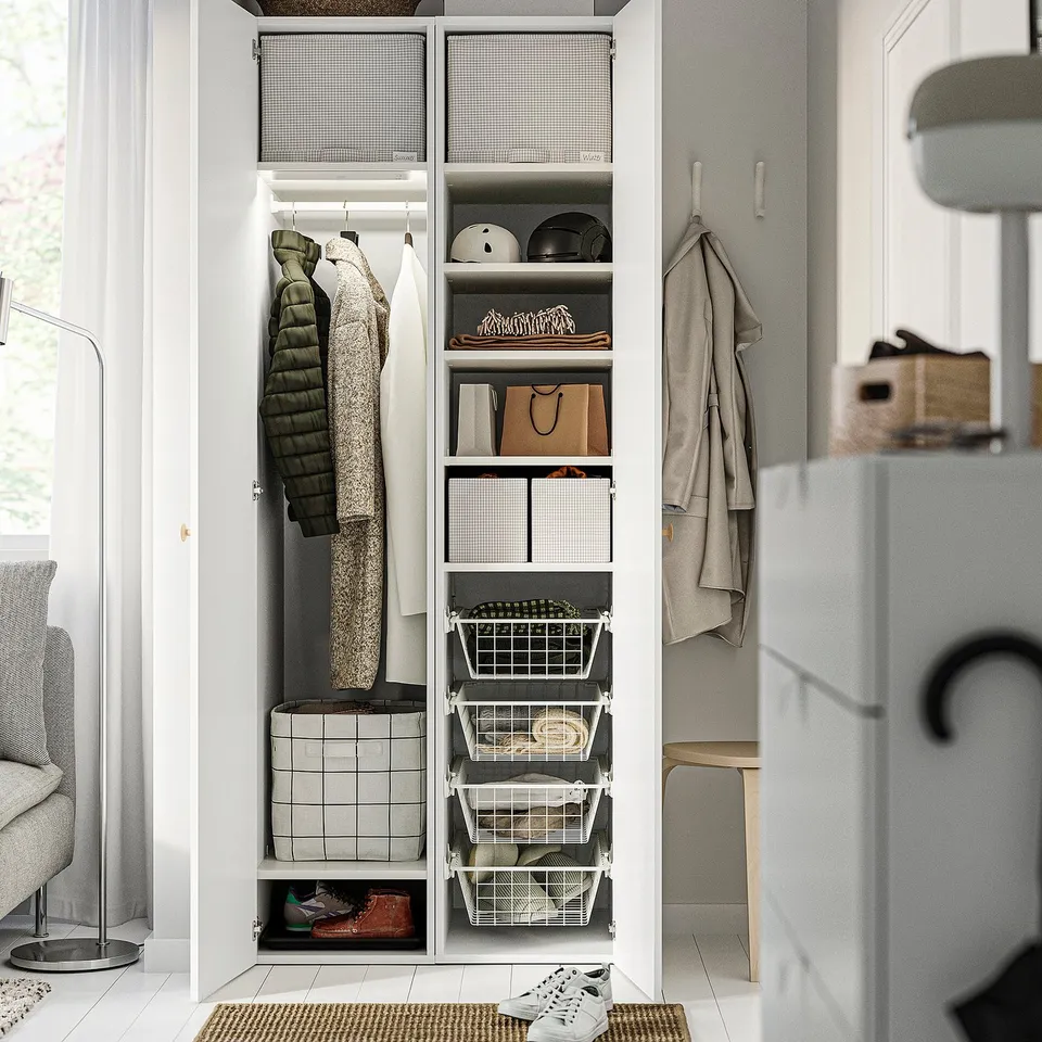 Well-organized closet with shelves and storage bins, including hanging garments.